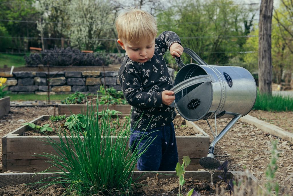 Bringing our children in contact with nature helps develop in them the love for nature A child gardening